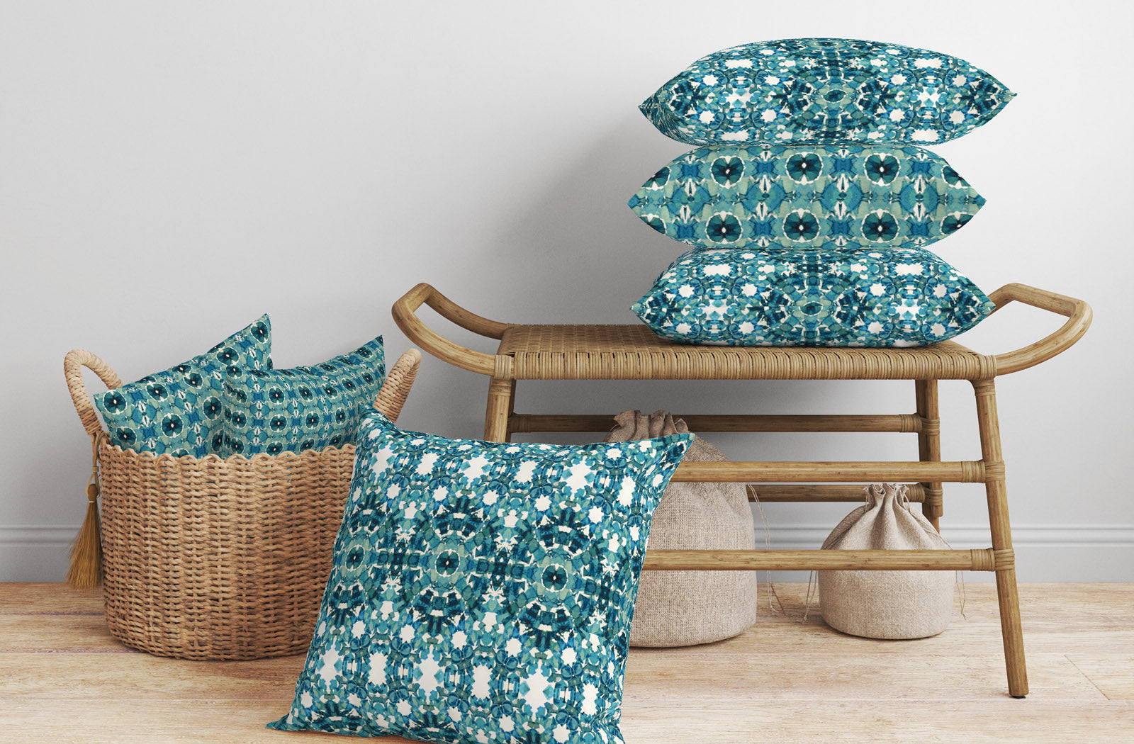 Woven bench and basket display with pillows featuring hand-painted teal patterns.