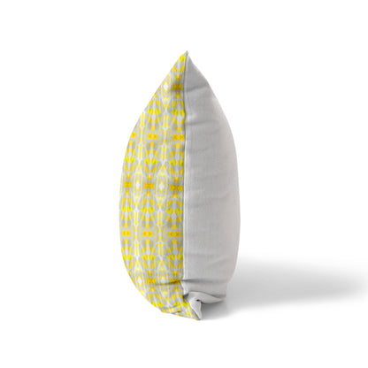 Side view of a pillow with a yellow patterned front and a solid white back