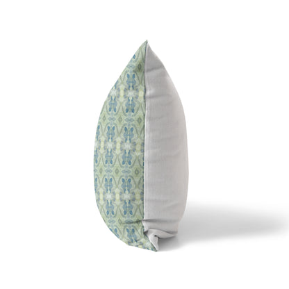 Side view of a pillow featuring an abstract blue and green pattern and a solid white back