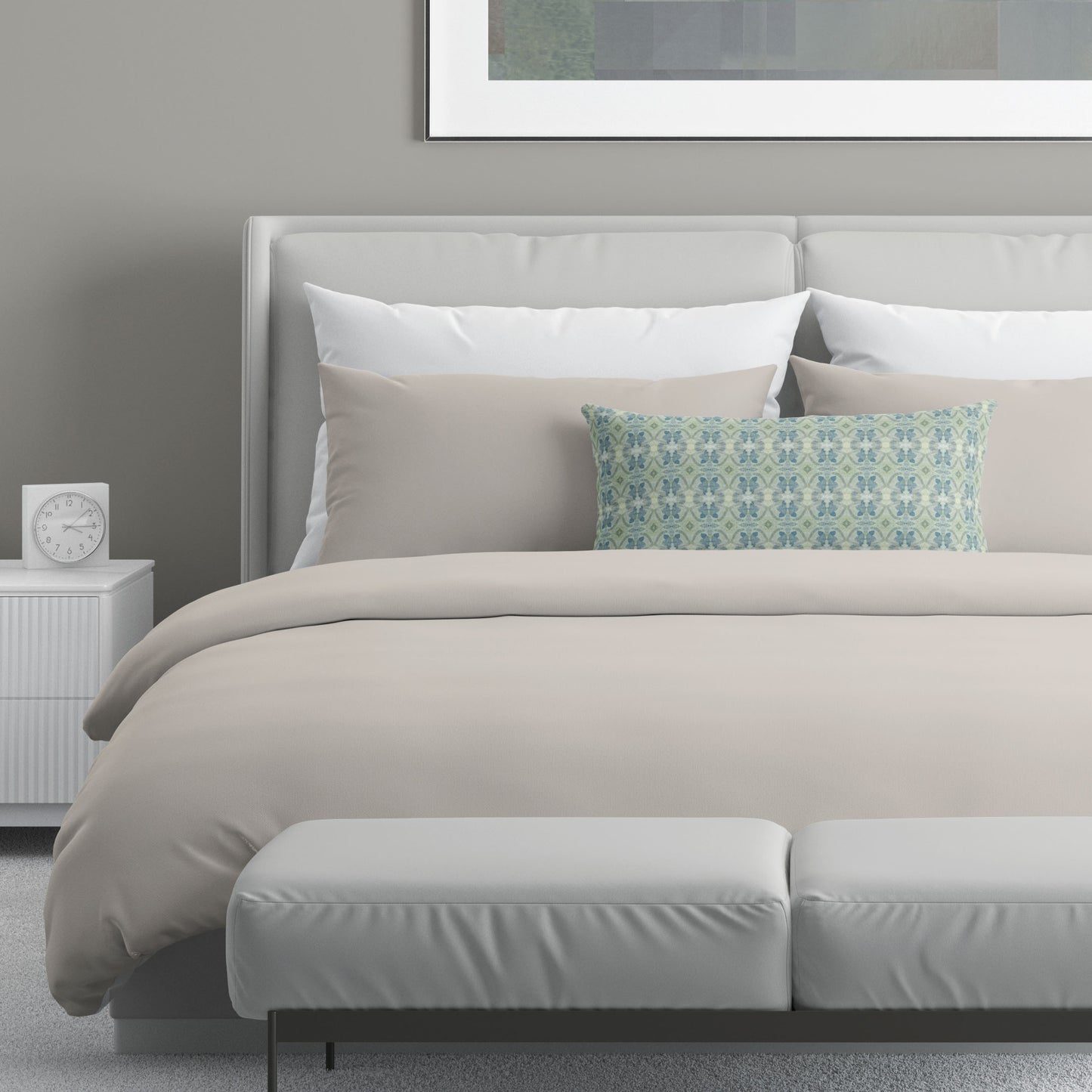 Neutral colored bedroom featuring a bed with an abstract patterned lumbar pillow.