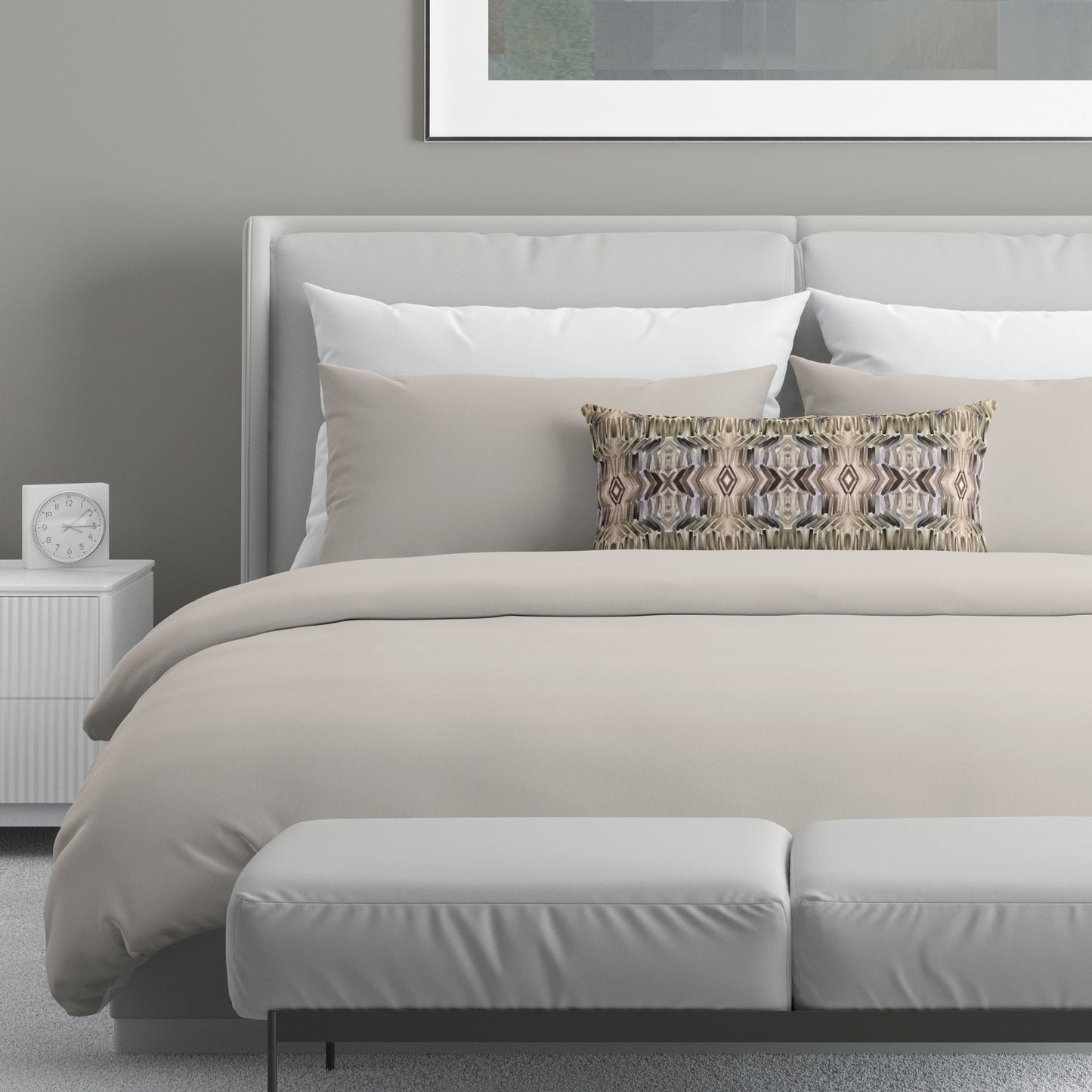 Neutral colored bedroom featuring a bed with an abstract patterned lumbar pillow.
