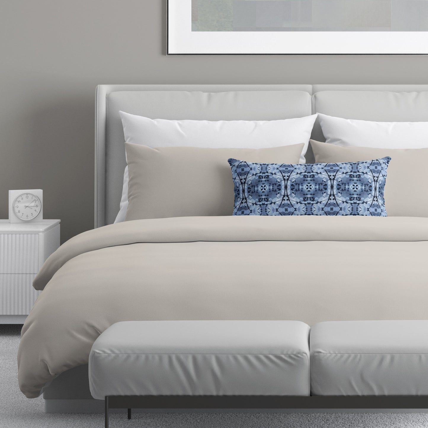 Neutral colored bedroom featuring a bed with a blue and black abstract patterned lumbar pillow.