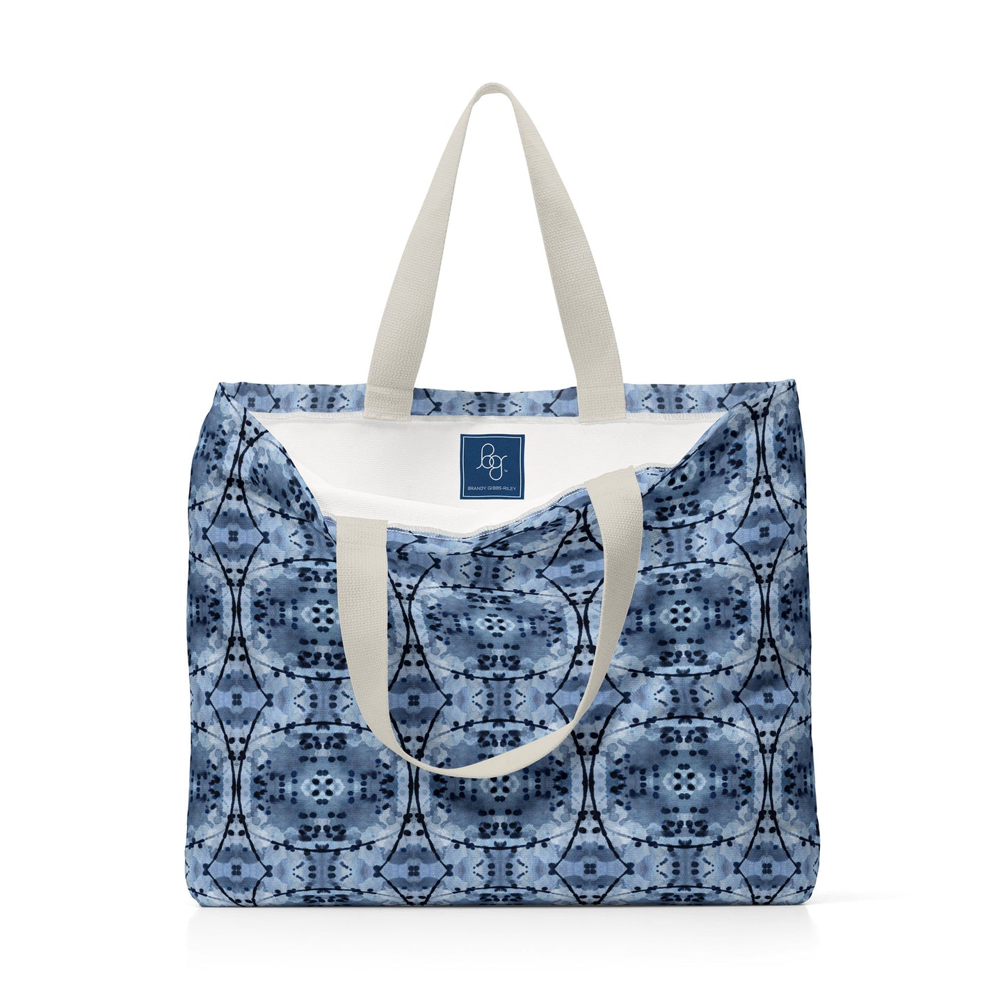 Oversized tote bag featuring an abstract hand-painted blue and black pattern and blue label