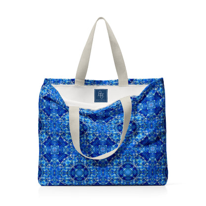 Bright blue tote bag featuring an abstract hand-painted pattern