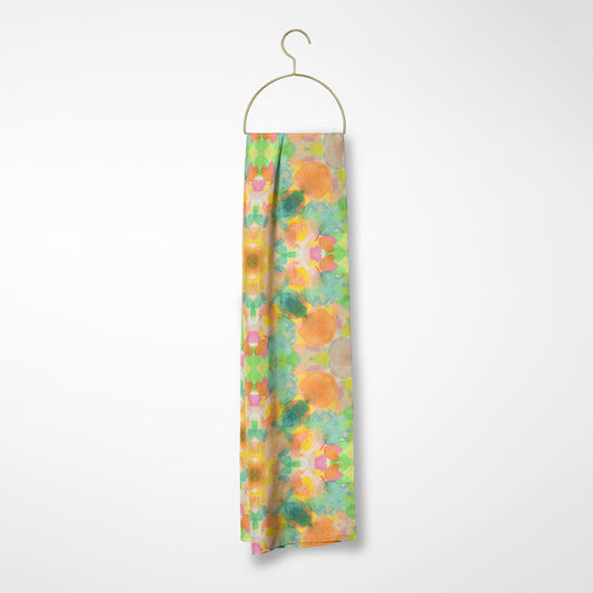 Silk scarf featuring an abstract peach and green hand-painted pattern