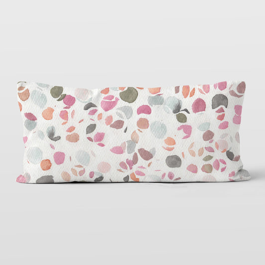 12x24 lumbar pillow, featuring an abstract watercolor painting of flower petals, on a white background.