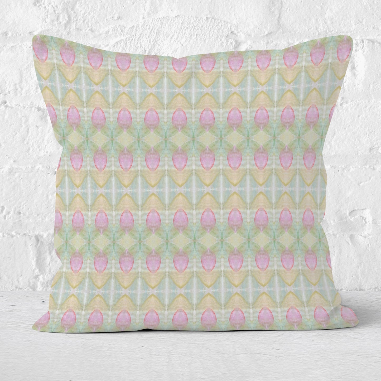 Square throw pillow featuring a pastel rosebud pattern in pink, green, blue, and peach