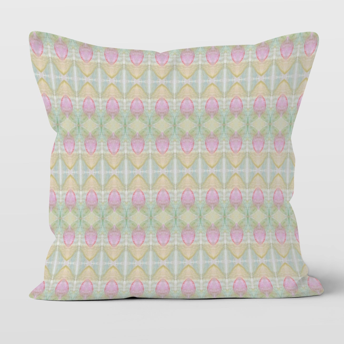 Square throw pillow featuring a pastel rosebud pattern in pink, green, blue, and peach