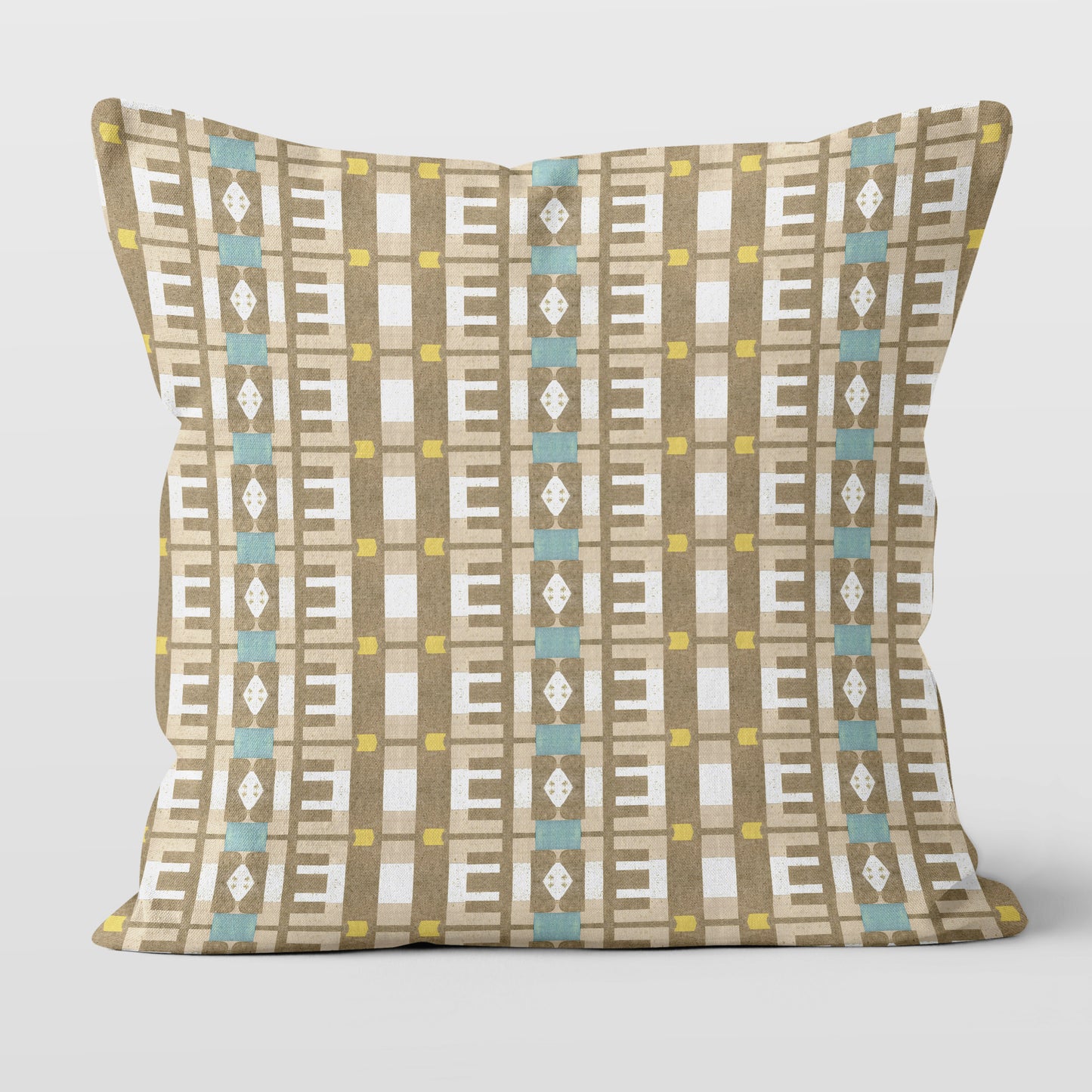 Throw pillow featuring a geometric tan and white pattern against a white wall