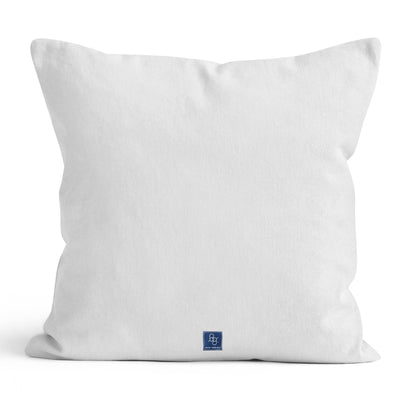 White back of pillow featuring a square navy blue tag