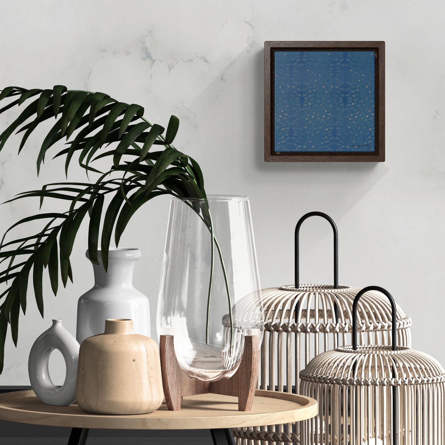 Framed mini canvas featuring a blue and fold abstract hand-painted print, hanging above a vases and lanterns