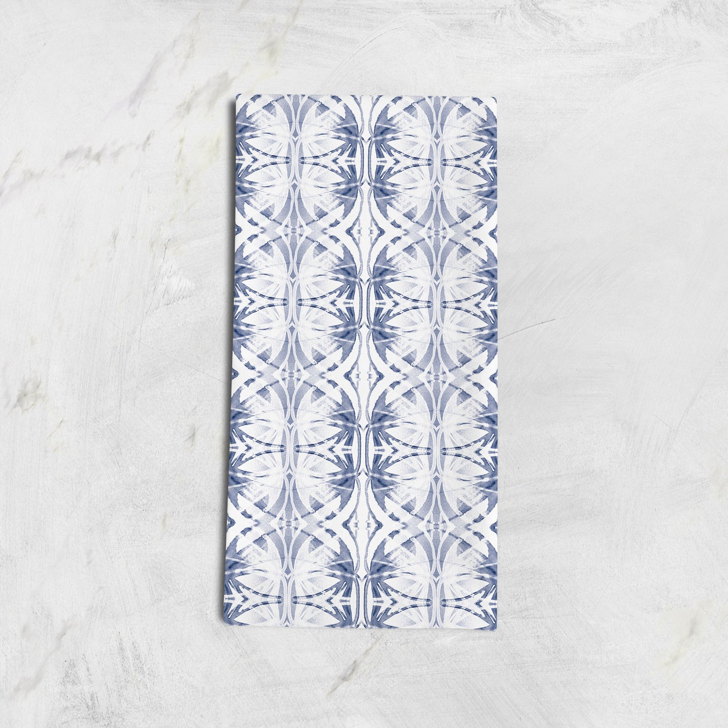 Folded cotton hemp tea towel featuring a blue and white abstract pattern