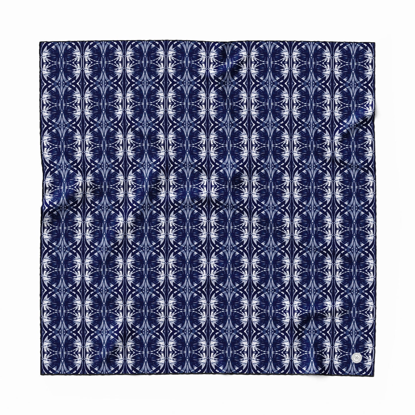 Silk scarf featuring a navy blue and white hand-painted pattern.