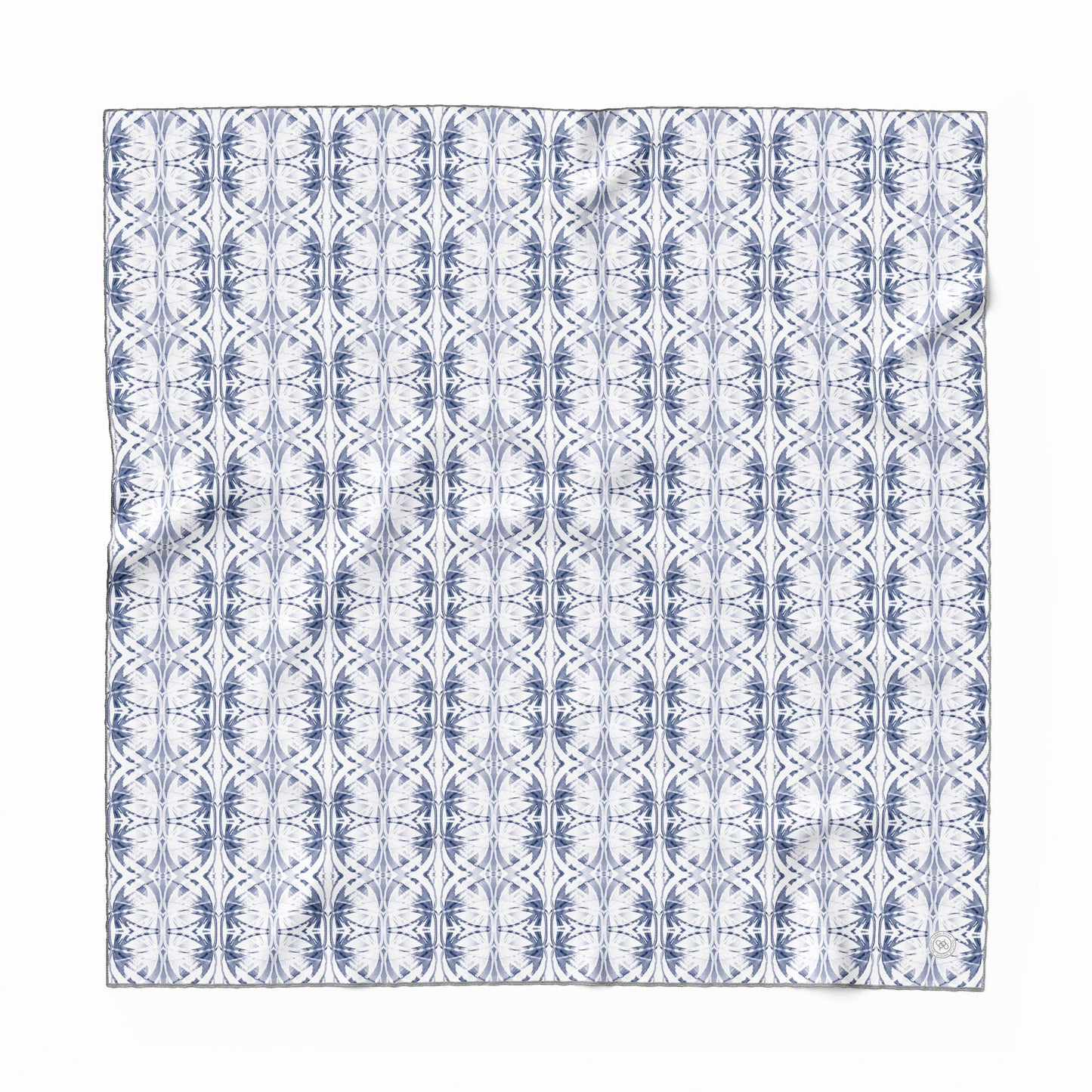 Silk scarf featuring a hand-painted blue and white pattern.