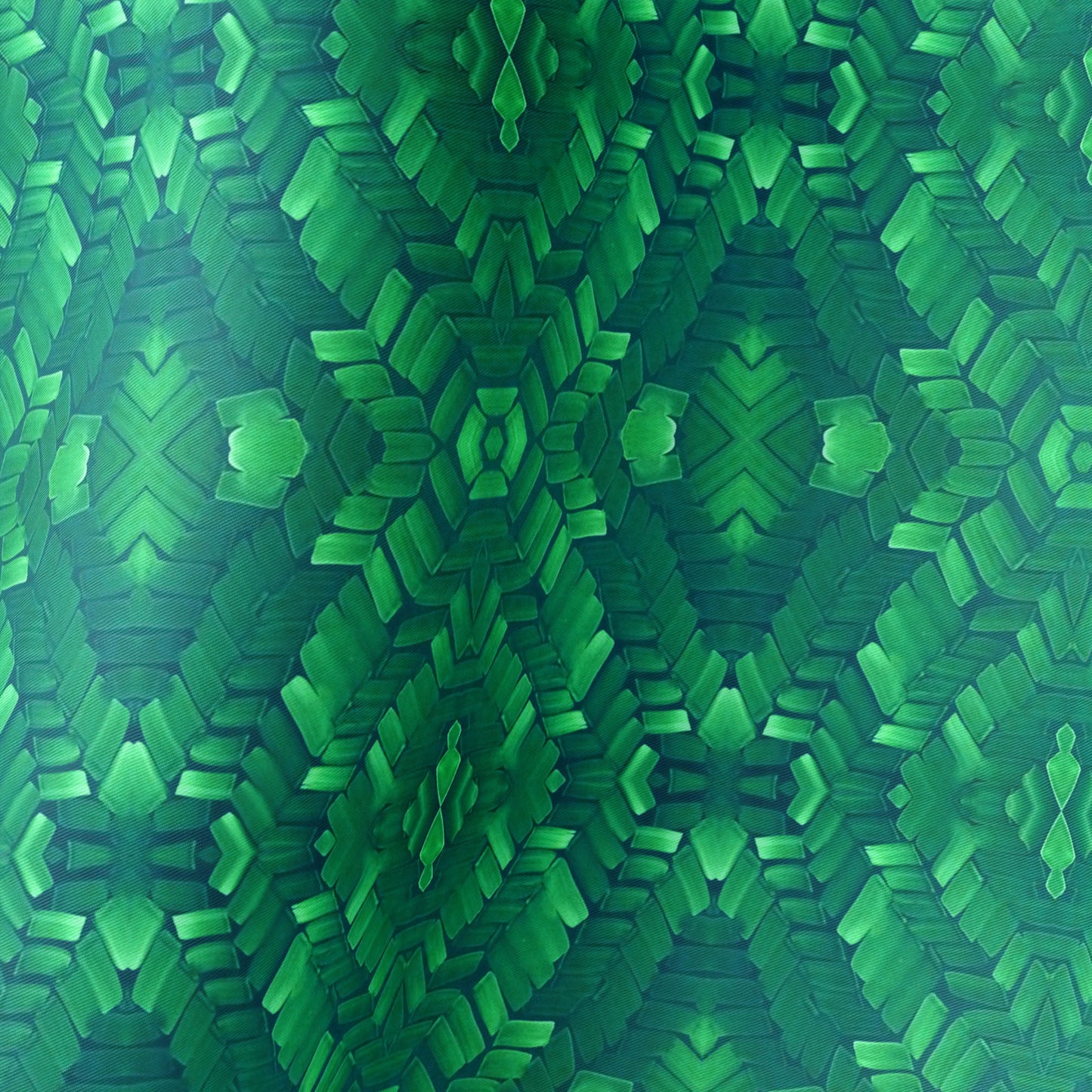 Detail of hand painted pattern on silk scarf in emerald green