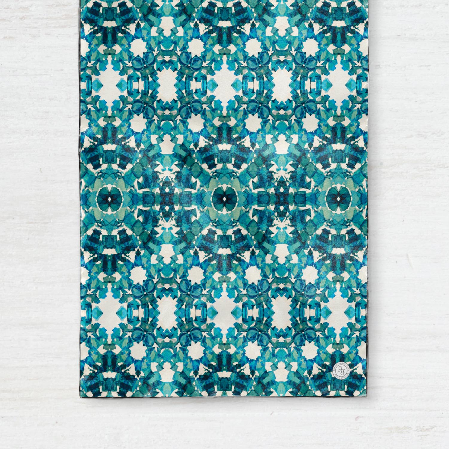 Detail of a silk scarf, featuring an abstract teal pattern