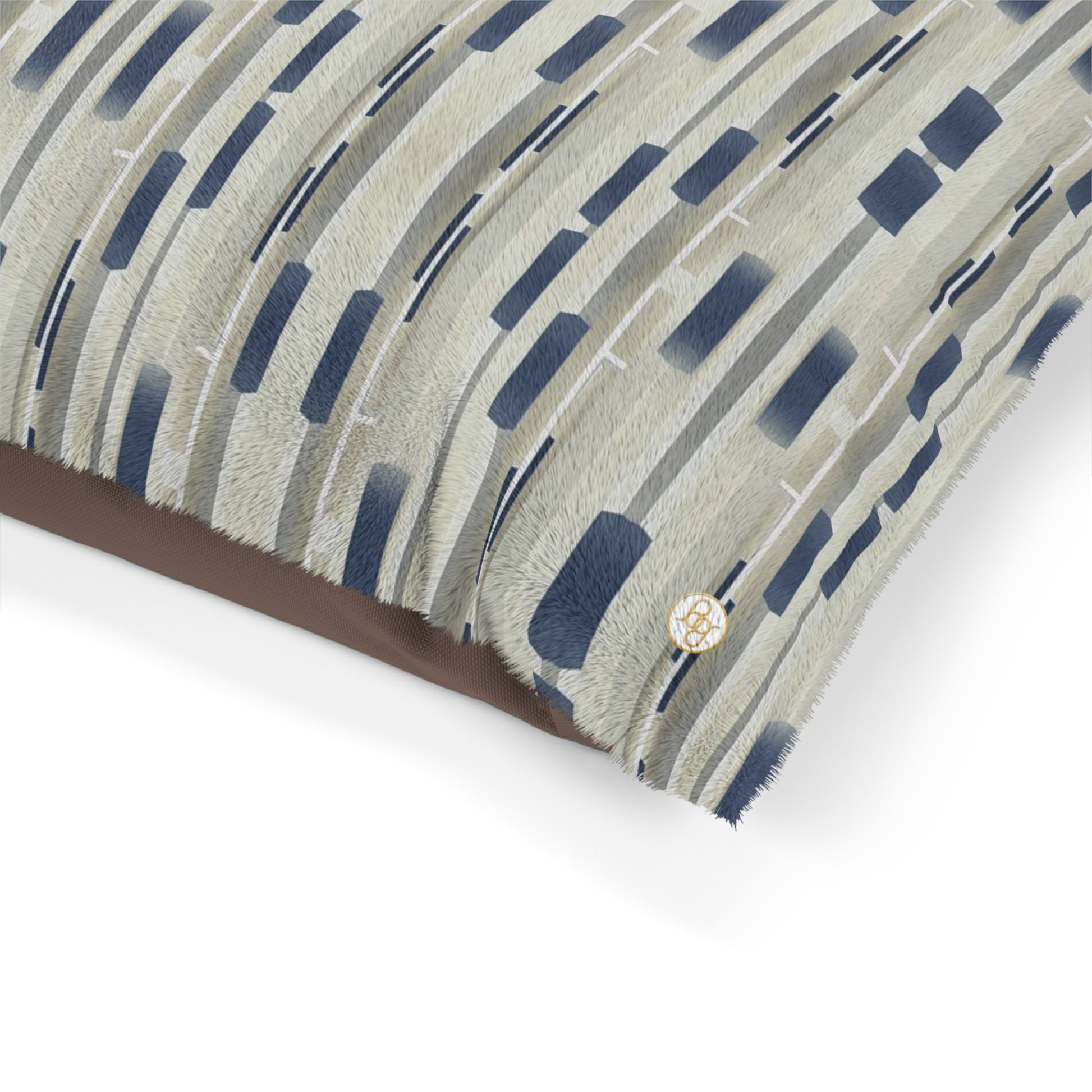 Fleece dog bed featuring a collaged stripe pattern in khaki and navy blue