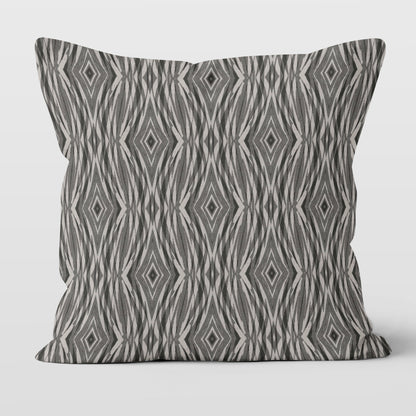 Throw pillow featuring an abstract pattern in grey and neutral tones.