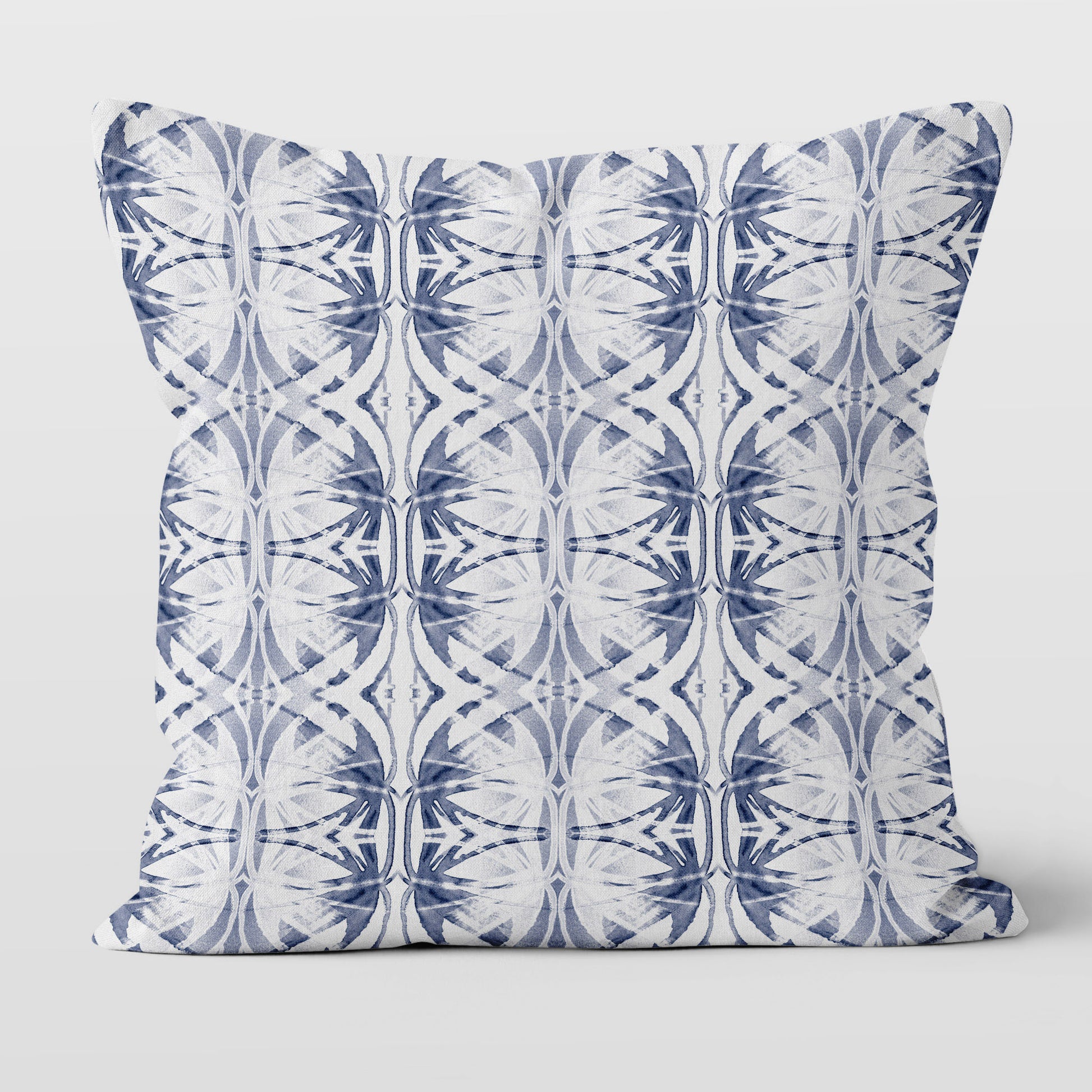 Throw pillow featuring abstract hand painted pattern in blue and white.
