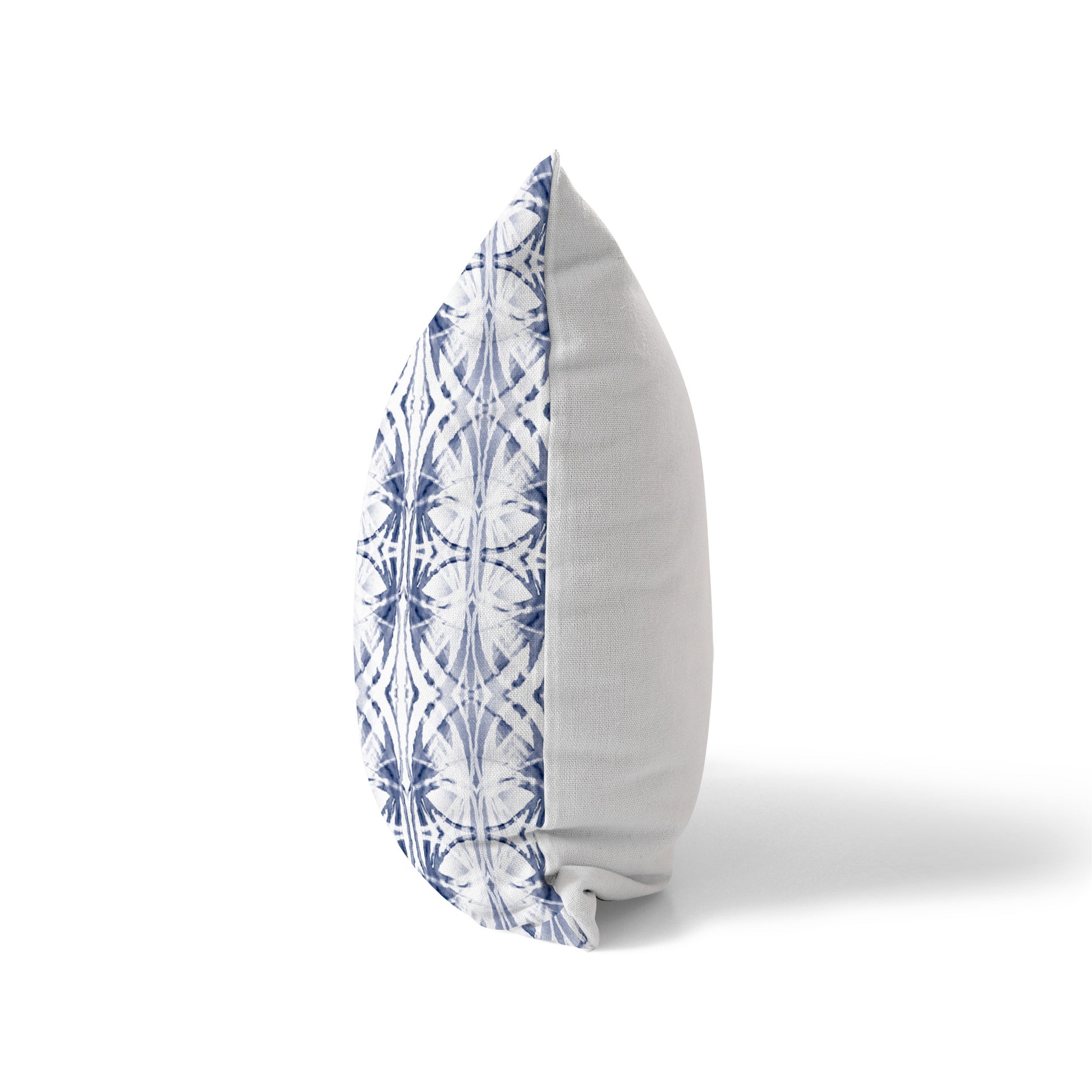 Side view of a pillow featuring a blue pattern on front and a white solid back