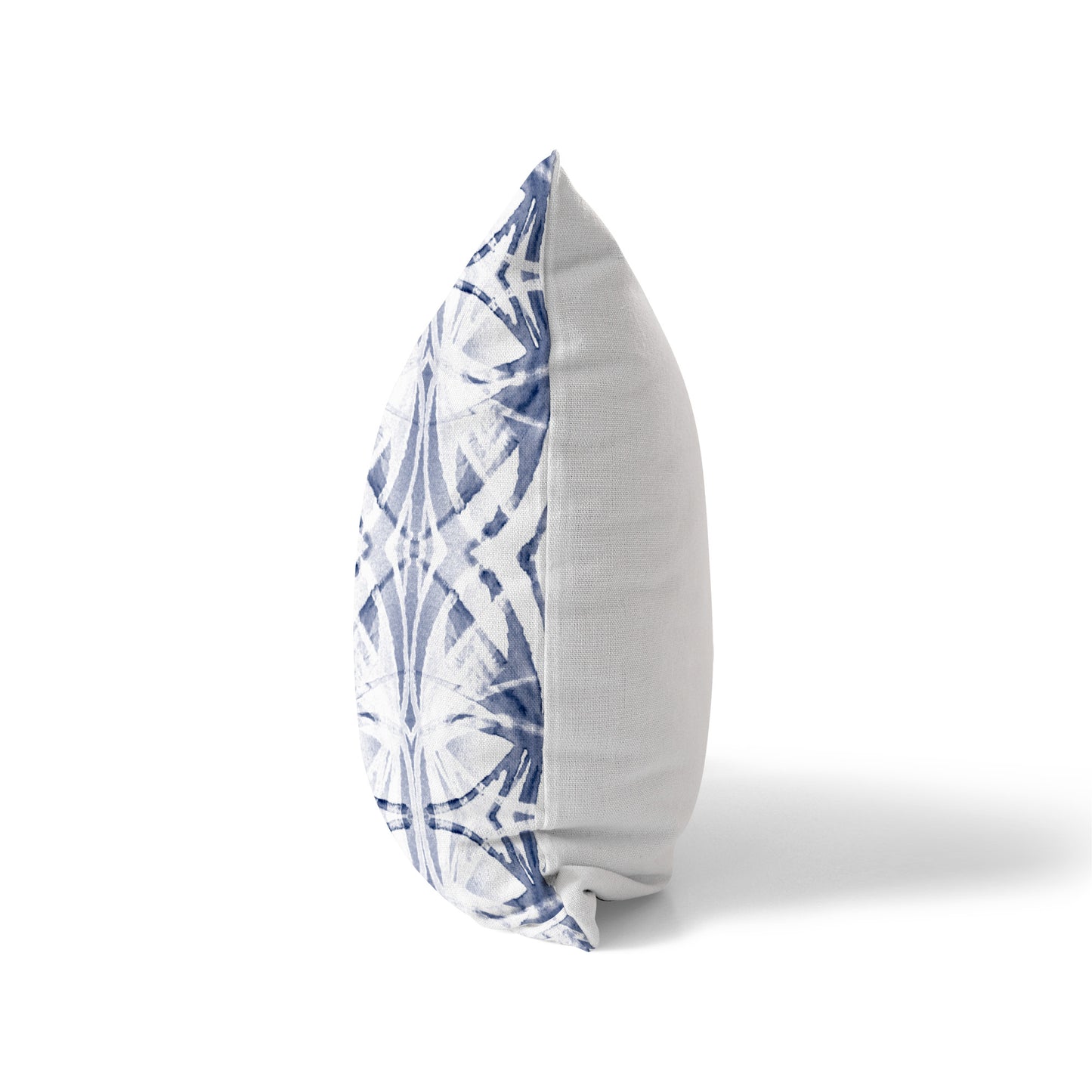 Sider view of a pillow featuring a blue and white abstract pattern and solid white back