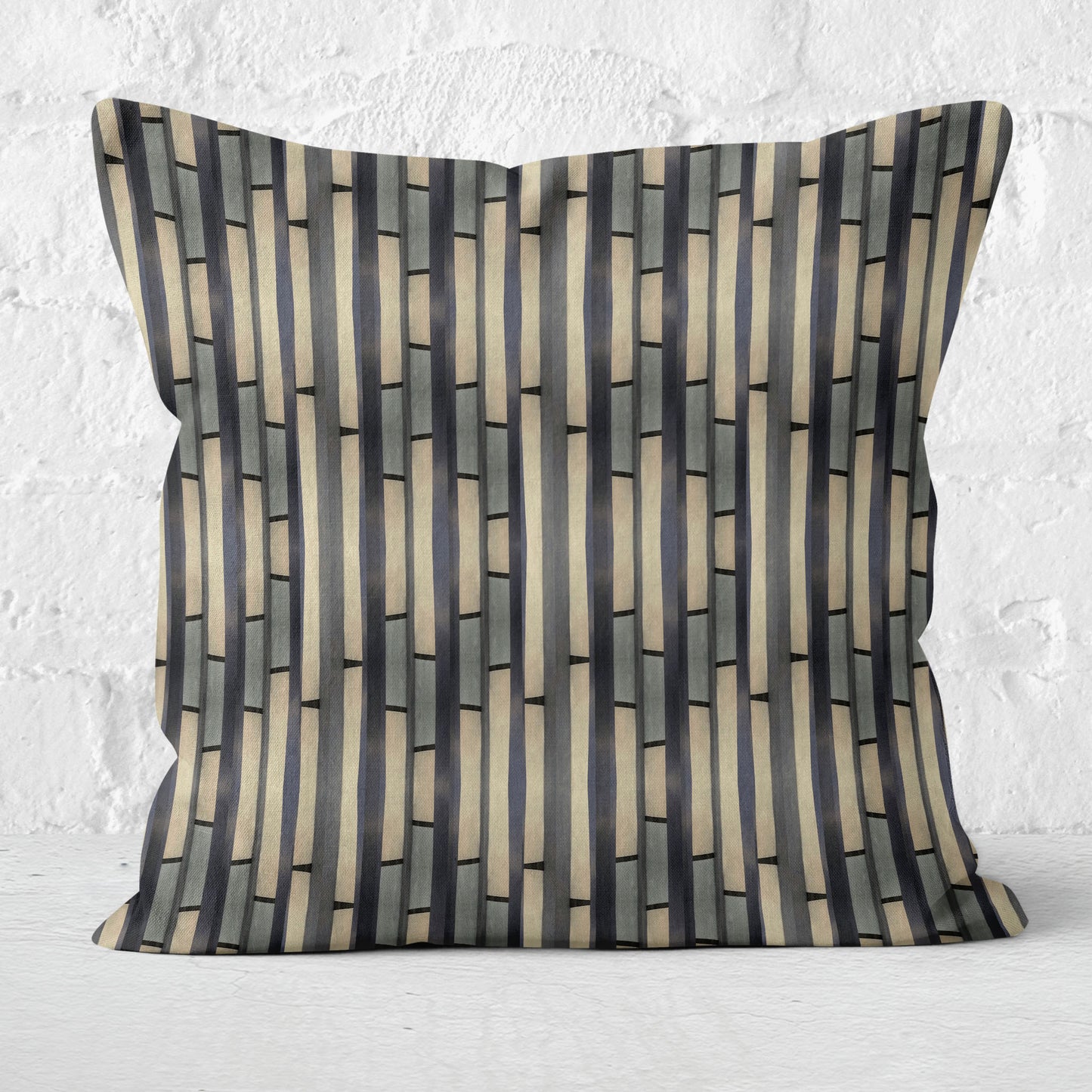 Abstract striped pillow on a white brick background