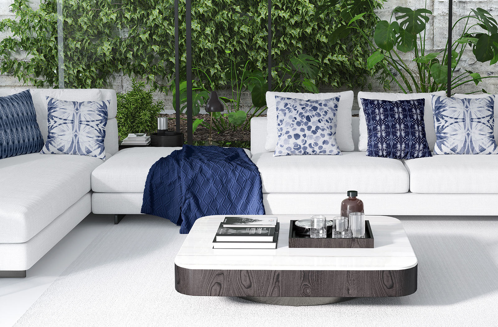 Modern living room scene featuring a collection of blue and white pillows on white couch