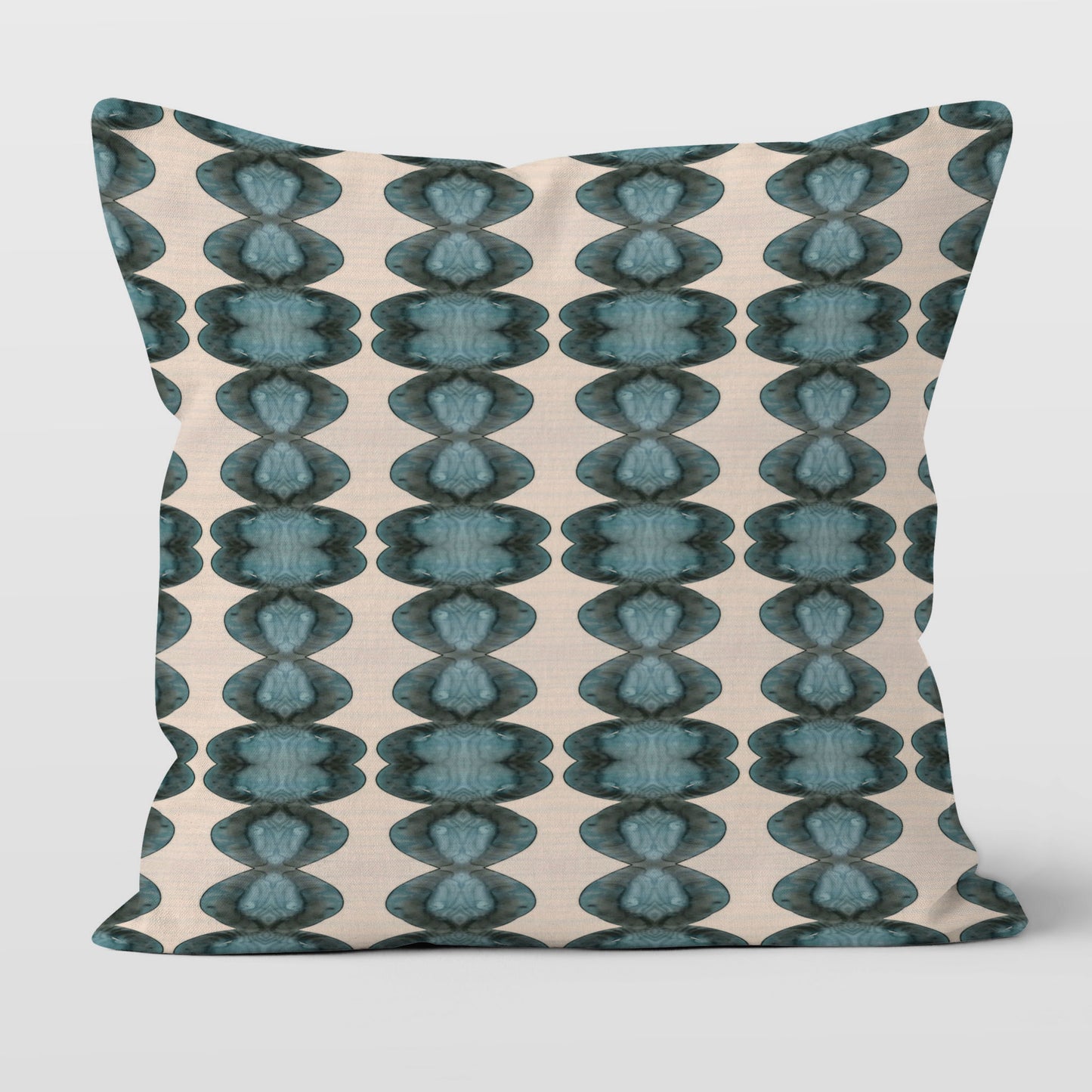 Throw pillow featuring abstract handprinted pattern in blue, black, and cream.