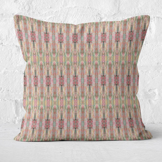 Throw pillow with abstract pink pattern on a white brick background.