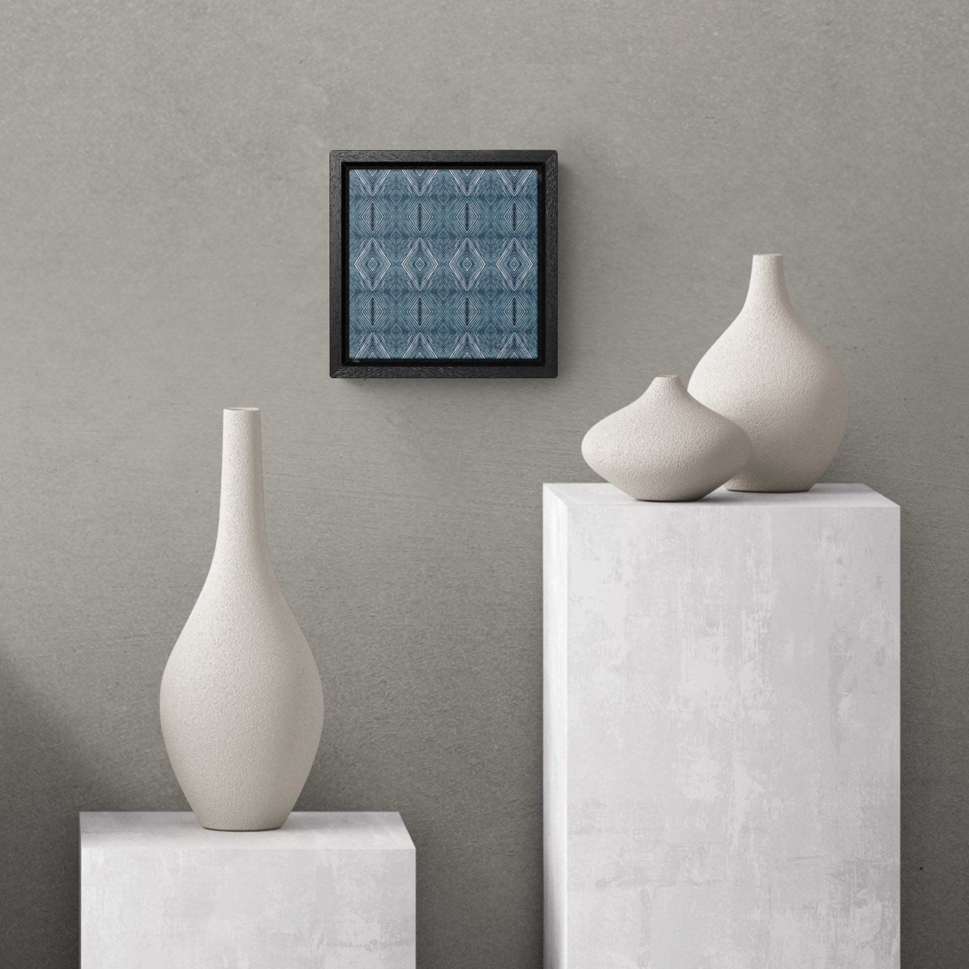 Abstract blue painting hanging above three white vases.