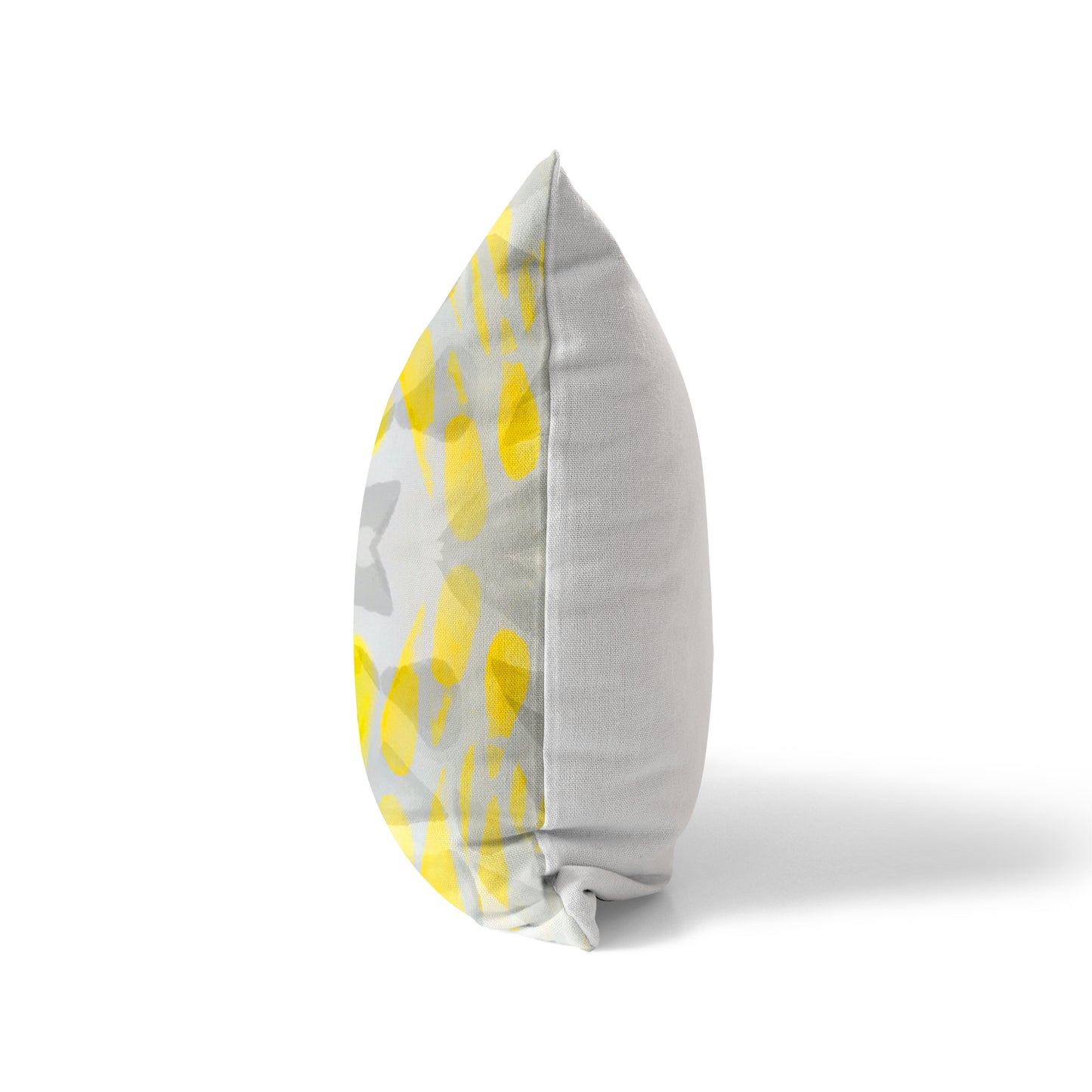 Side view of a pillow featuring a yellow and gray pattern and a solid whit back