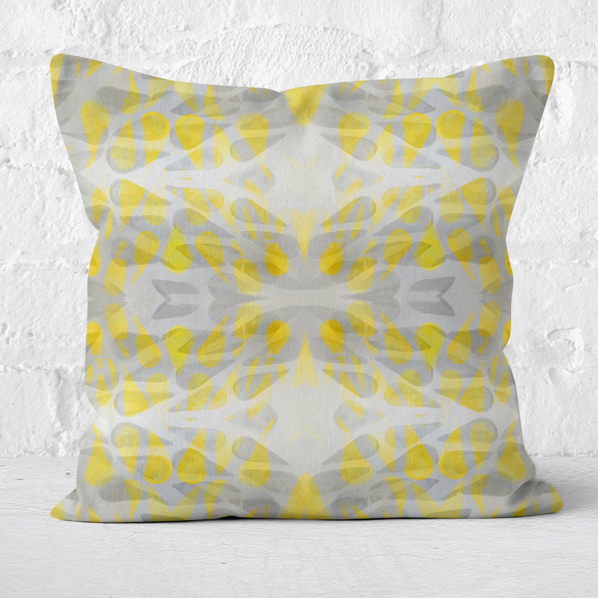 Throw pillow featuring abstract hand-painted pattern in yellow and grey.
