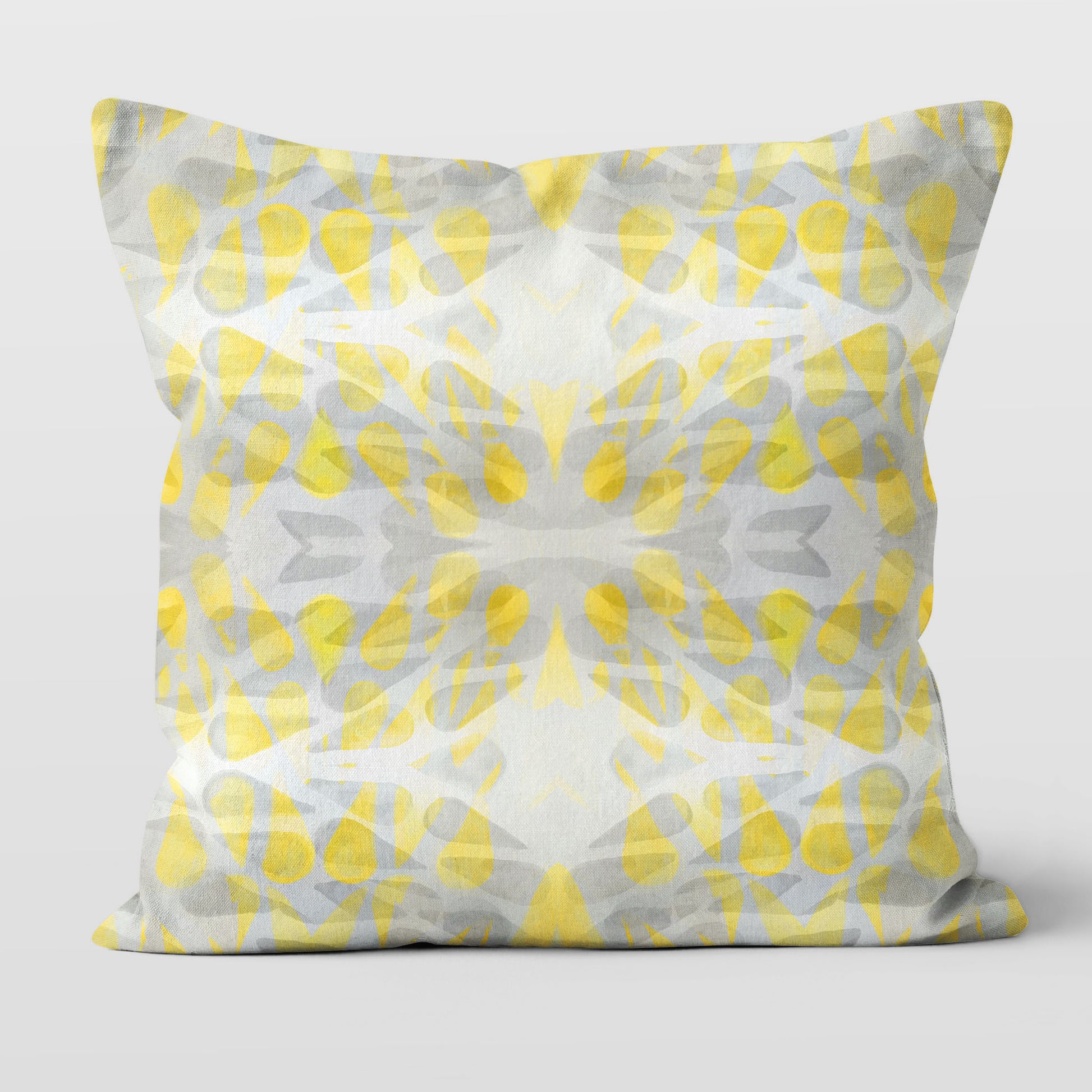 Throw pillow featuring abstract hand-painted pattern in yellow and grey.