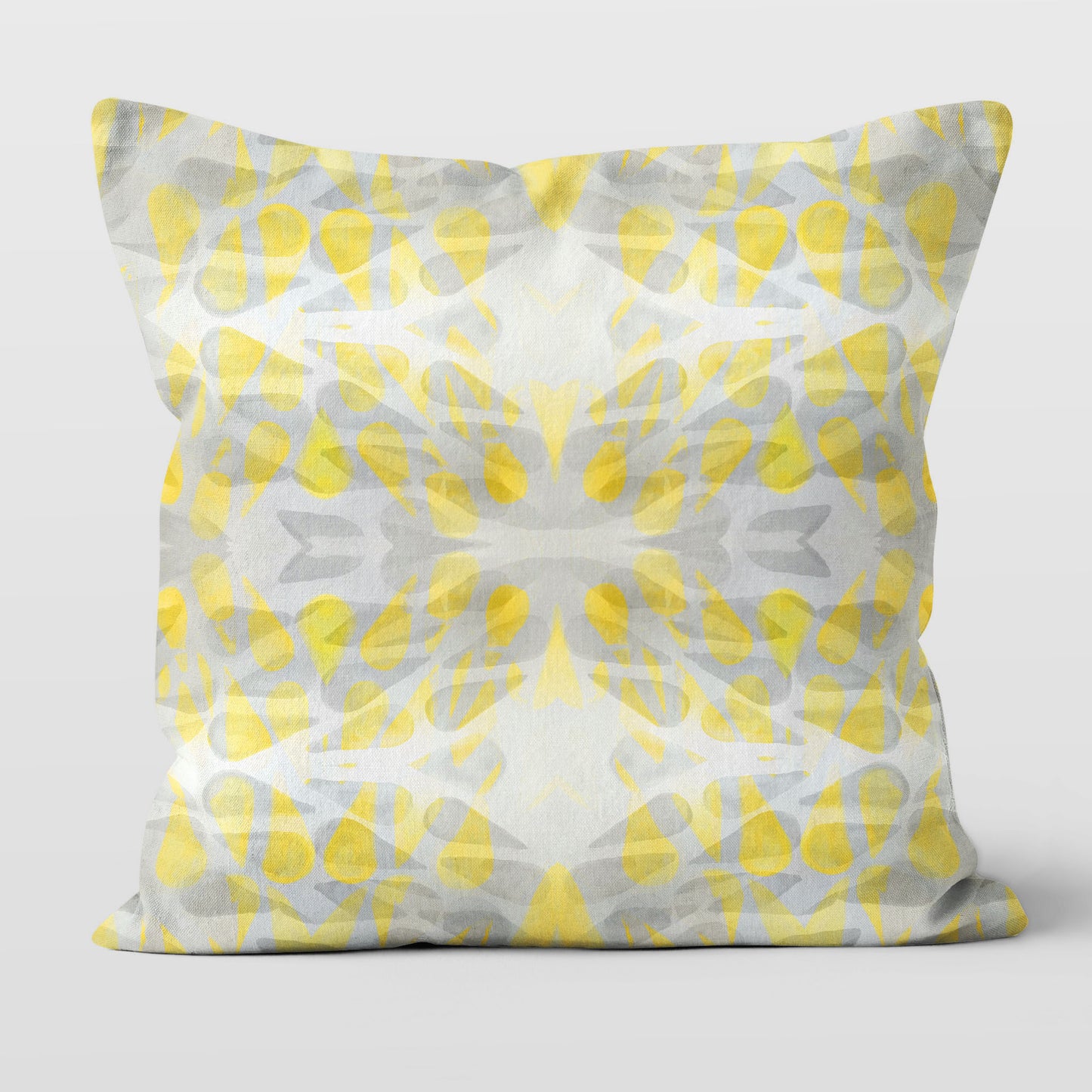 Throw pillow featuring abstract hand-painted pattern in yellow and grey.