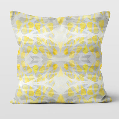 Throw pillow featuring abstract hand-painted pattern in yellow and grey.