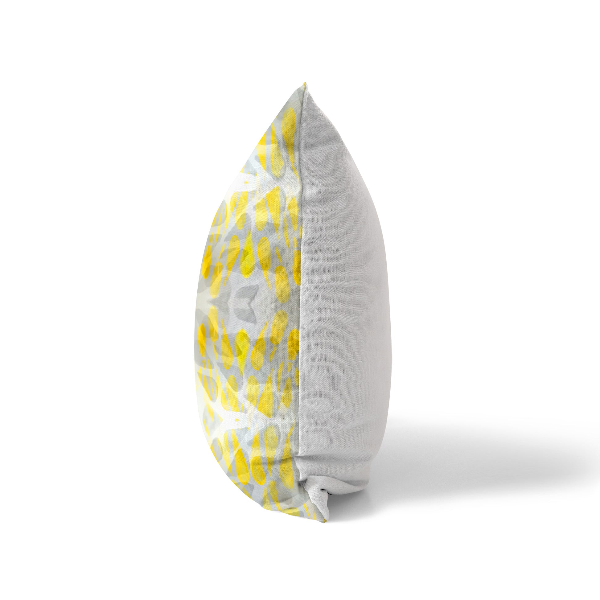 Side view of a pillow featuring a yellow pattern on the front and a white solid back