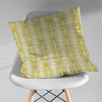 Yellow patterned pillow sitting on a white modernist chair