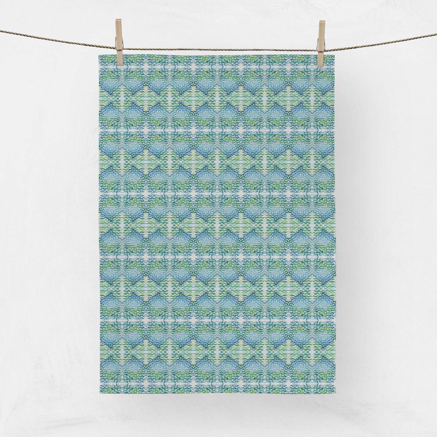 Hanging tea towel featuring a green and blue pattern