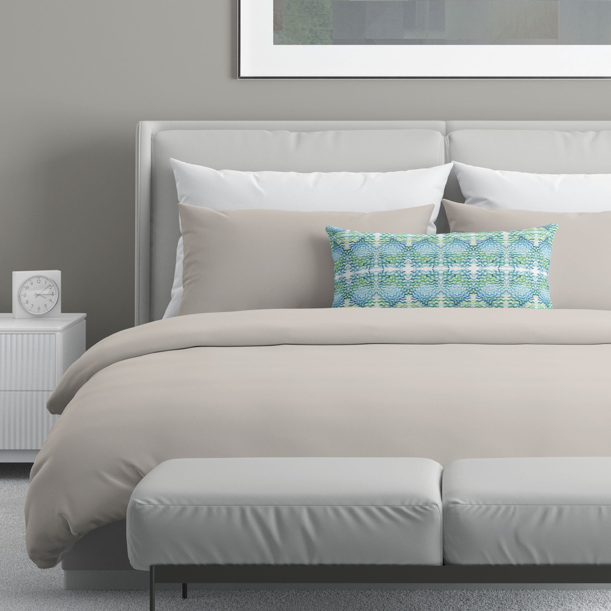Neutral colored bedroom featuring a bed with an abstract patterned lumbar pillow.