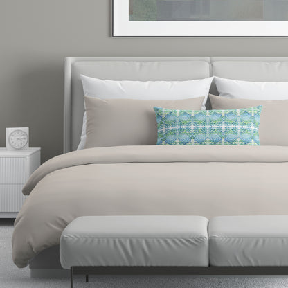 Neutral colored bedroom featuring a bed with an abstract patterned lumbar pillow.