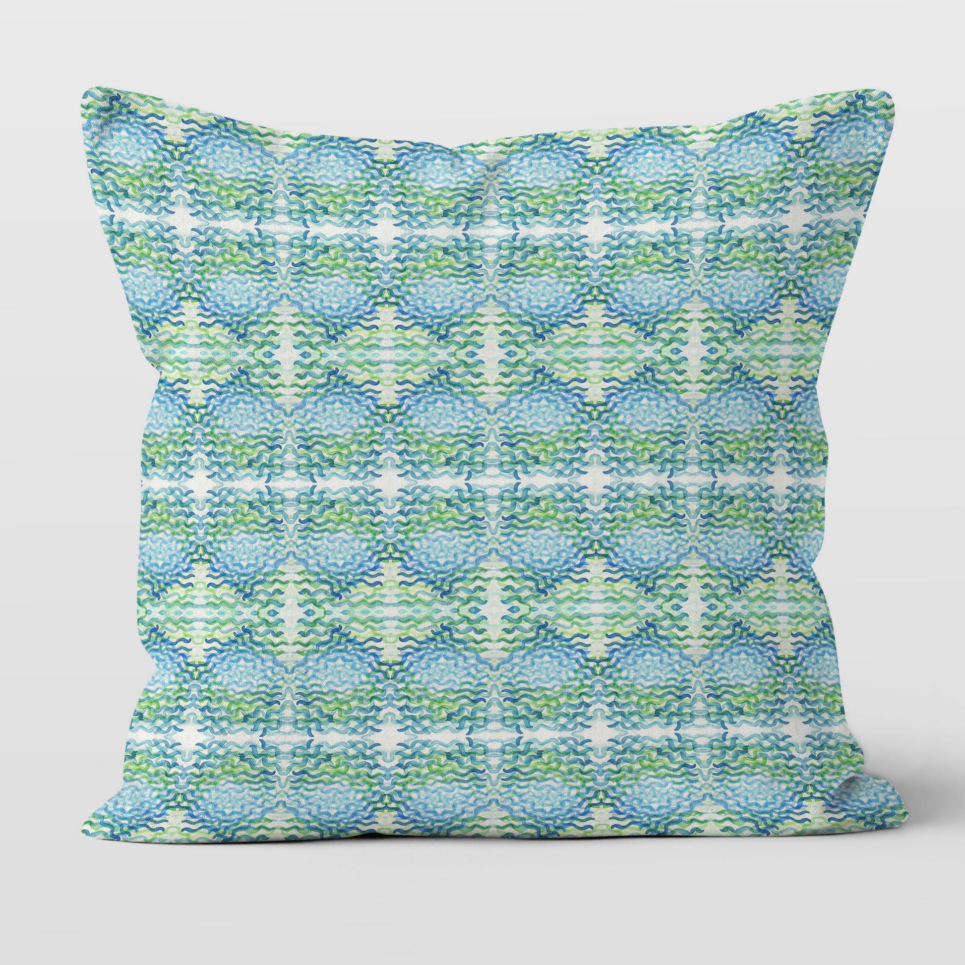 Throw pillow featuring a blue and green abstract, hand-painted watercolor pattern.