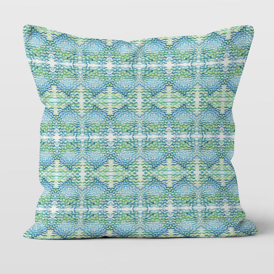 Throw pillow featuring a blue and green abstract, hand-painted watercolor pattern.