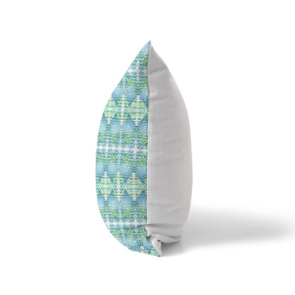 Side view of a pillow, featuring a blue and green pattern on front and solid white back