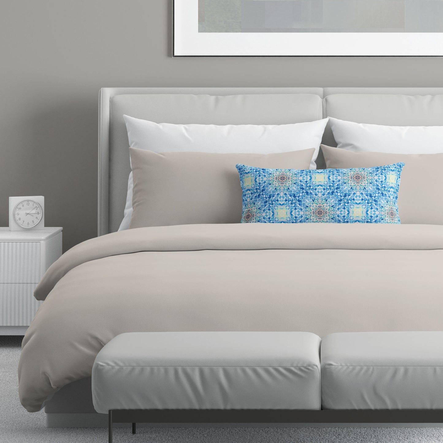 Neutral colored bedroom featuring a bed with a blue abstract patterned lumbar pillow.