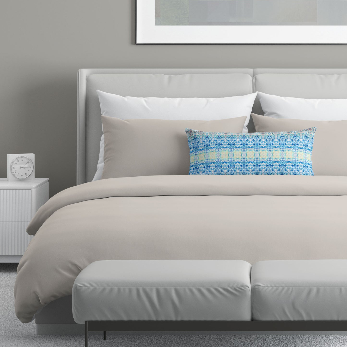 Neutral colored bedroom featuring a bed with a blue and yellow abstract patterned lumbar pillow.
