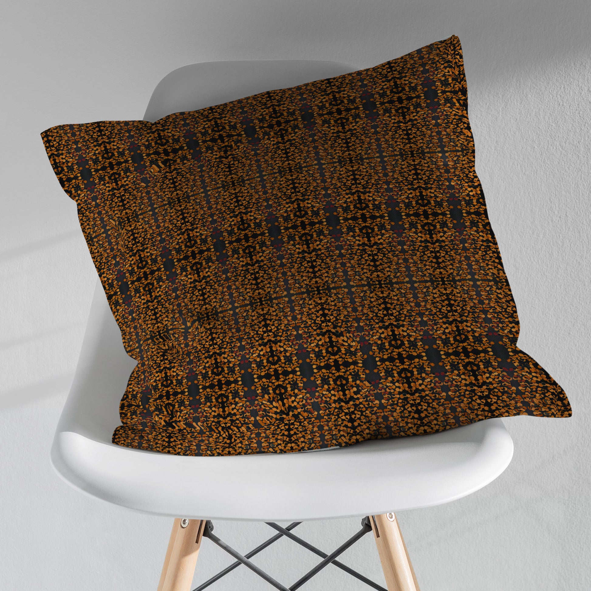 Copper and black abstract pattern sitting on a white modernist chair