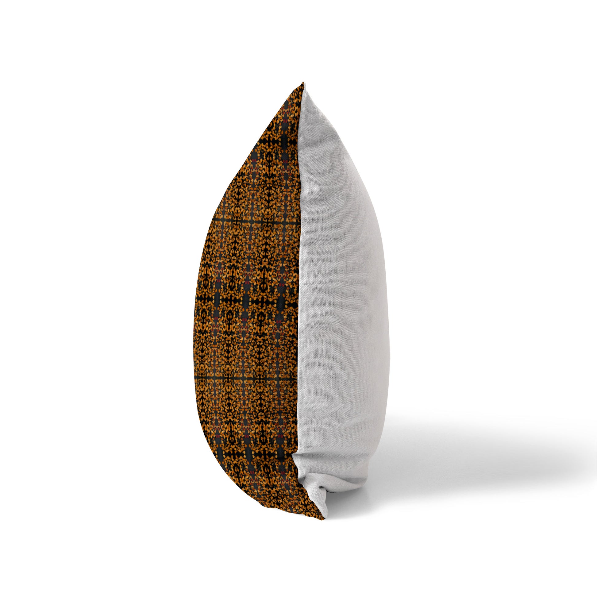 Side view of a pillow featuring a brown and black abstract pattern and a solid white back