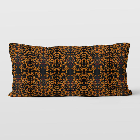Rectangular lumbar pillow featuring a hand-painted black and copper tone pattern.