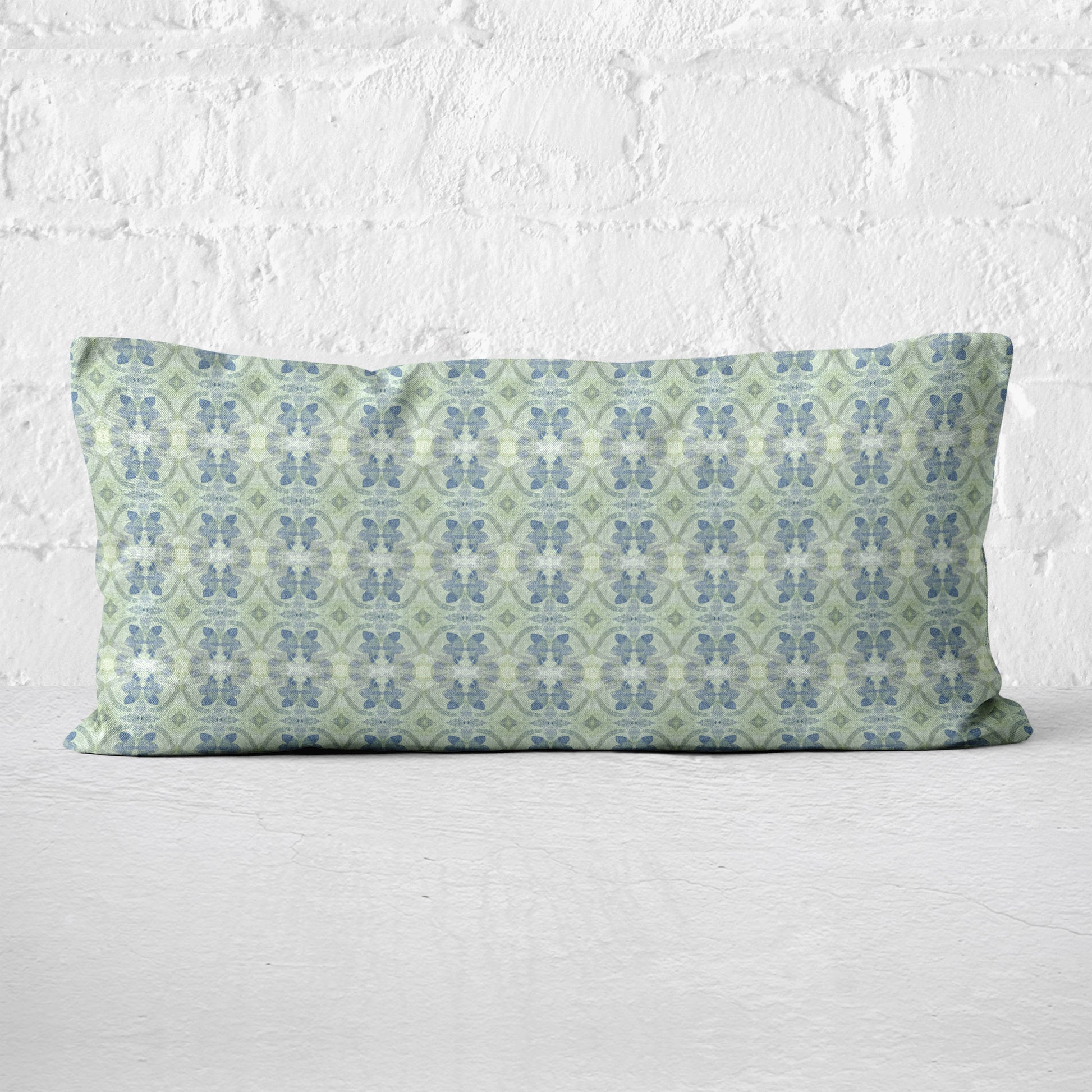 Lumbar pillow featuring a hand-painted green and blue abstract pattern