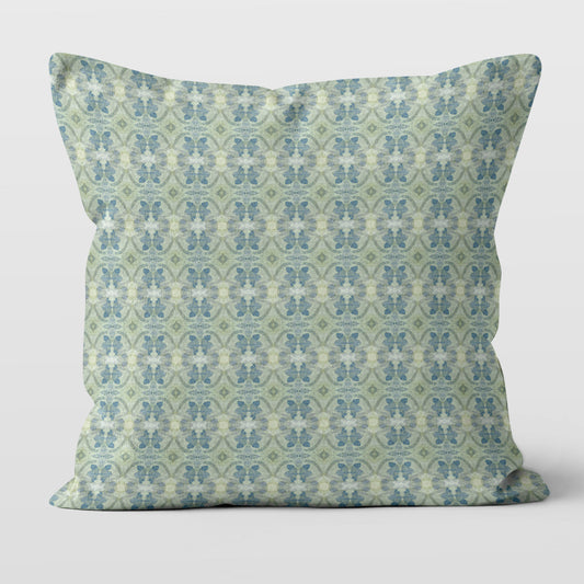 Square throw pillow featuring a blue and green abstract floral pattern